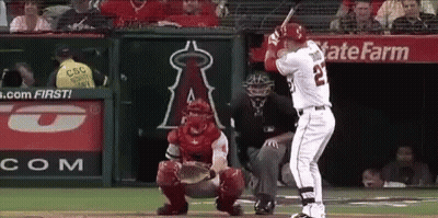 A Baseball Player With The Number 22 On His Jersey Is Swinging His Bat GIF