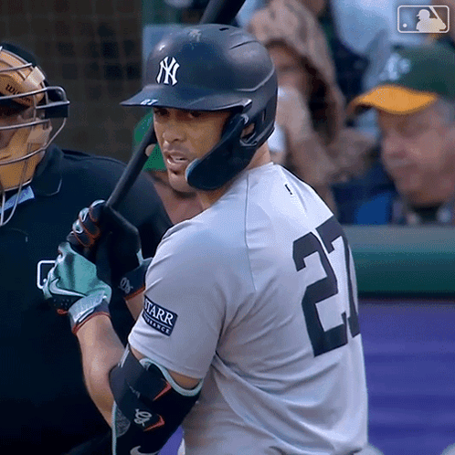 A Baseball Player With The Number 25 On His Jersey Is About To Swing His Bat GIF