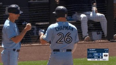 a baseball player with the number 26 on his back shakes hands with another player