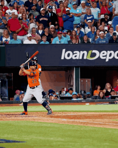 A Baseball Player With The Number 27 On His Jersey Is Swinging At A Pitch GIF