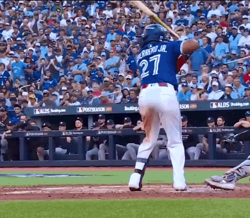 A Baseball Player With The Number 27 On His Jersey Is Swinging His Bat GIF