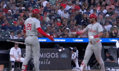 A Baseball Player With The Number 28 On His Back Shakes Hands With Another Player GIF