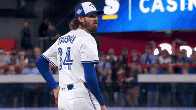 a baseball player with the number 34 on his jersey stands on the field