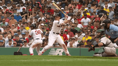 A Baseball Player With The Number 38 On His Back Is Swinging His Bat GIF