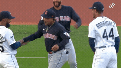 A Baseball Player With The Number 44 On His Jersey Shakes Hands With Another Player . GIF