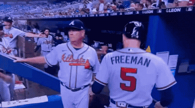 A Baseball Player With The Number 5 On His Back Talks To Another Player GIF
