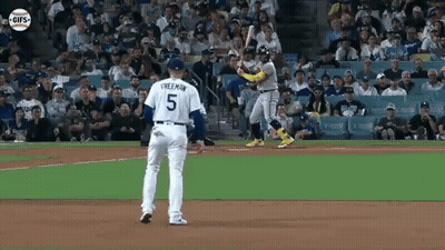 A Baseball Player With The Number 5 On His Jersey Is Swinging A Bat At A Ball . GIF