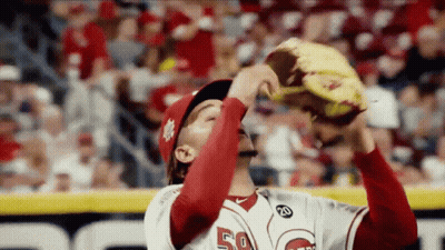 A Baseball Player With The Number 50 On His Jersey Is Holding His Glove Up In The Air . GIF