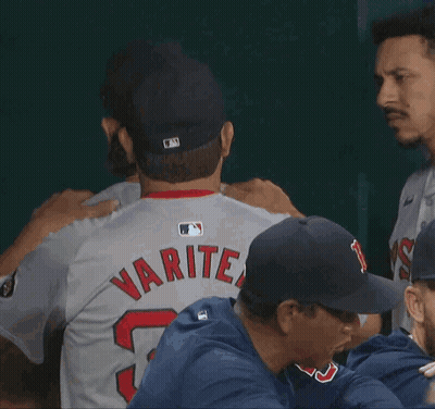 A Baseball Player With The Number 52 On His Jersey Is Hugging Another Player GIF