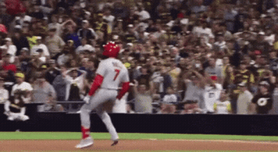 A Baseball Player With The Number 7 On His Jersey Is Running Towards The Base GIF