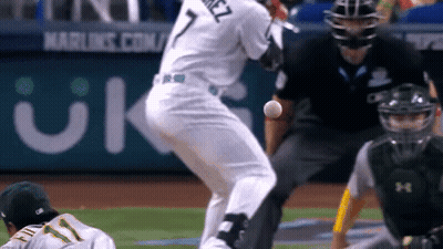 A Baseball Player With The Number 7 On His Jersey Is Swinging At A Ball GIF