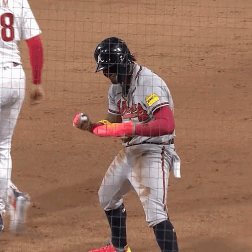 A Baseball Player With The Number 8 On His Jersey Stands On The Field GIF