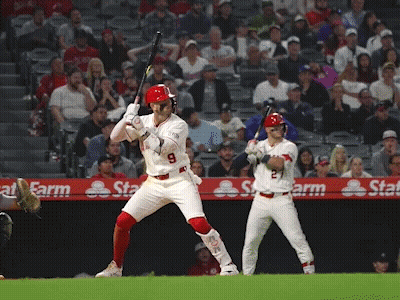 A Baseball Player With The Number 9 On His Jersey Swings His Bat GIF