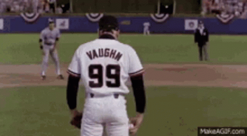 A Baseball Player With The Number 99 On His Back Is Standing On A Field . GIF