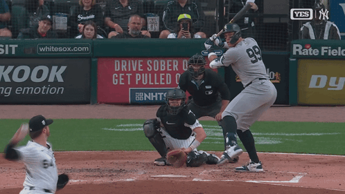 A Baseball Player With The Number 99 On His Jersey Swings At The Ball GIF