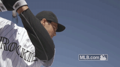 A Baseball Player With The Word Rockies On His Jersey Throws A Ball GIF