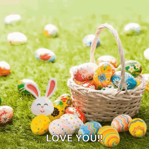 A Basket Filled With Easter Eggs And A Bunny On The Grass With The Words Love You ! GIF