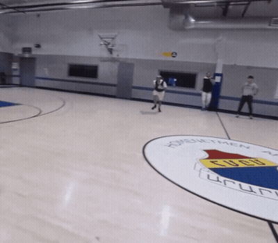 A Basketball Court With A Logo For Homenetmen On It GIF