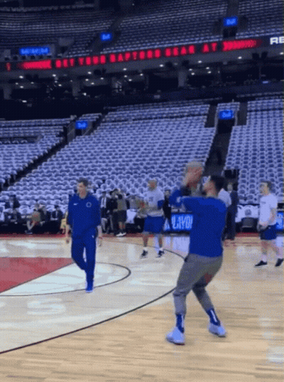 A Basketball Court With A Sign That Says " Get Your Raptors Bear At " GIF