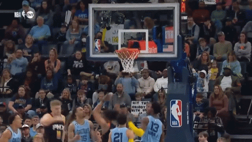 A Basketball Game Being Played In Front Of A Crowd With A Sign That Says Hit The Crispy GIF