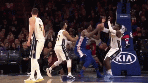 A Basketball Game Being Played In Front Of A Kia Advertisement GIF
