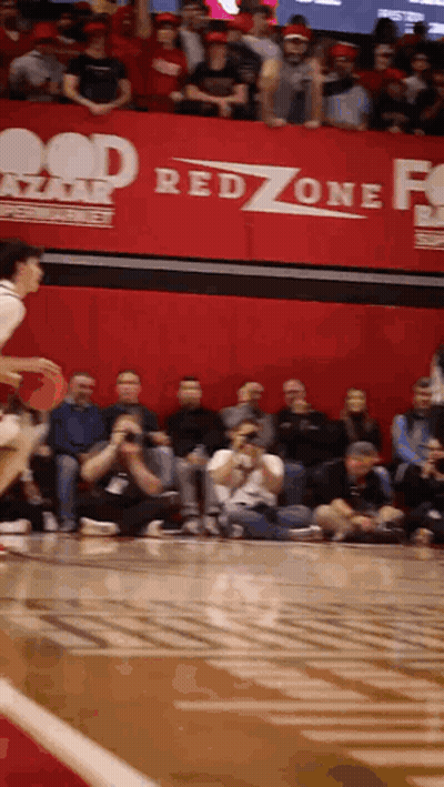 A Basketball Game Being Played In Front Of A Red Zone Sign GIF