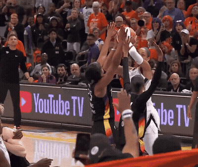 A Basketball Game Being Played In Front Of A Youtube Tv Banner GIF
