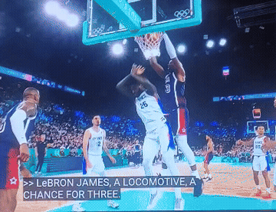 A Basketball Game Is Being Played And Lebron James Is Dunking GIF