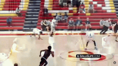 A Basketball Game Is Being Played In A Gym With A Ballislife.com Logo On The Court GIF