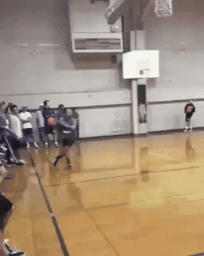 A Basketball Game Is Being Played In A Gym With A Player Wearing A Shirt That Says ' Basketball ' GIF