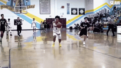 A Basketball Game Is Being Played In A Gym With The Word Slam On The Wall GIF