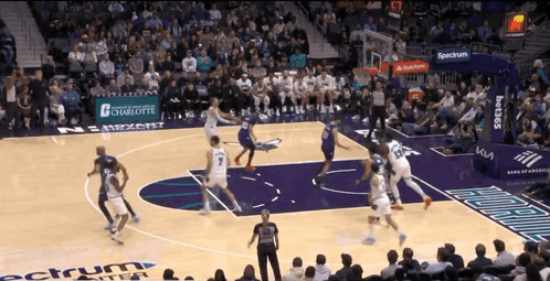 A Basketball Game Is Being Played In A Stadium With A Banner For Spectrum In The Background GIF