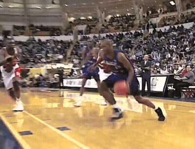A Basketball Game Is Being Played In A Stadium With A Few People Watching GIF