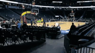 A Basketball Game Is Being Played In An Empty Stadium With People Sitting In The Stands . GIF