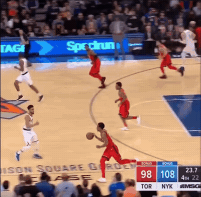 A Basketball Game Is Being Played In Front Of A Banner For Spectrum GIF