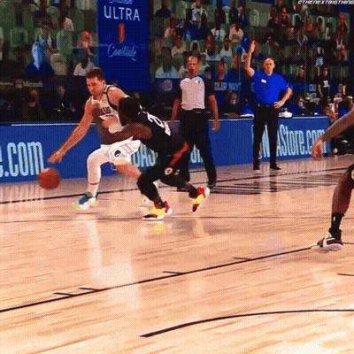 A Basketball Game Is Being Played In Front Of A Banner For Ultra GIF