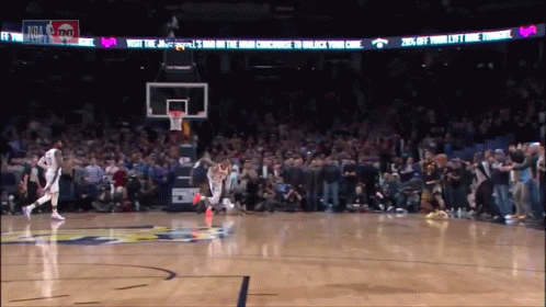 A Basketball Game Is Being Played In Front Of A Banner That Says Visit The Jazz Bar On The Way Concourse To Unlock Your  GIF