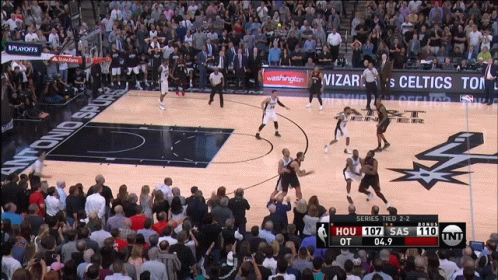A Basketball Game Is Being Played In Front Of A Crowd GIF