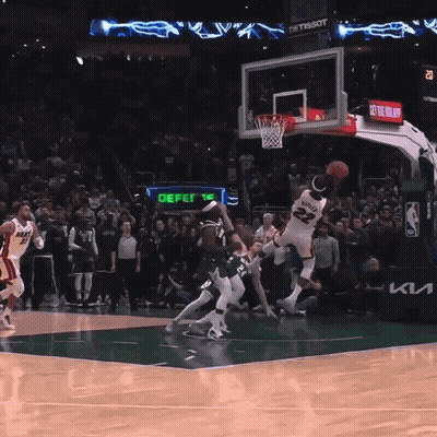 A Basketball Game Is Being Played In Front Of A Crowd And A Sign That Says Defer GIF