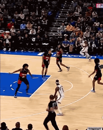 A Basketball Game Is Being Played In Front Of A Crowd And A Sign That Says Tonight On It GIF
