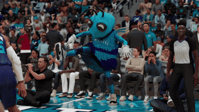 A Basketball Game Is Being Played In Front Of A Crowd And The Mascot For The Hornets Is Dancing GIF