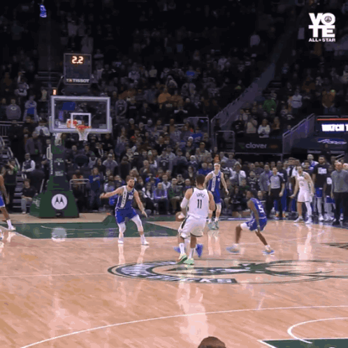 A Basketball Game Is Being Played In Front Of A Crowd And The Scoreboard Says 22 GIF