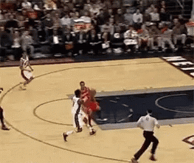 A Basketball Game Is Being Played In Front Of A Crowd GIF