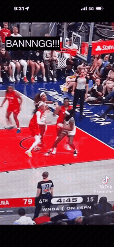 A Basketball Game Is Being Played In Front Of A Crowd Of People . GIF