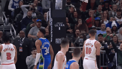 A Basketball Game Is Being Played In Front Of A Crowd That Is Cheering For The Bucks GIF