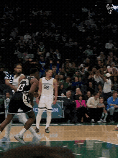 A Basketball Game Is Being Played In Front Of A Crowd That Is Watching GIF