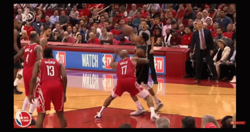 A Basketball Game Is Being Played In Front Of A Crowd With A Banner That Says Watch On It GIF