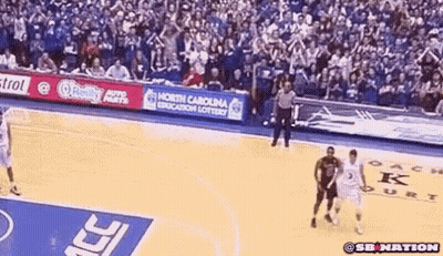 A Basketball Game Is Being Played In Front Of A Crowd With A North Carolina Education Lottery Banner GIF