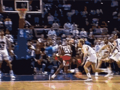 A Basketball Game Is Being Played In Front Of A Crowd With A Player Wearing The Number 23 GIF
