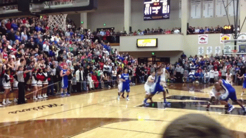 A Basketball Game Is Being Played In Front Of A Crowd With A Scoreboard That Shows The Score Of 41 To 17 GIF